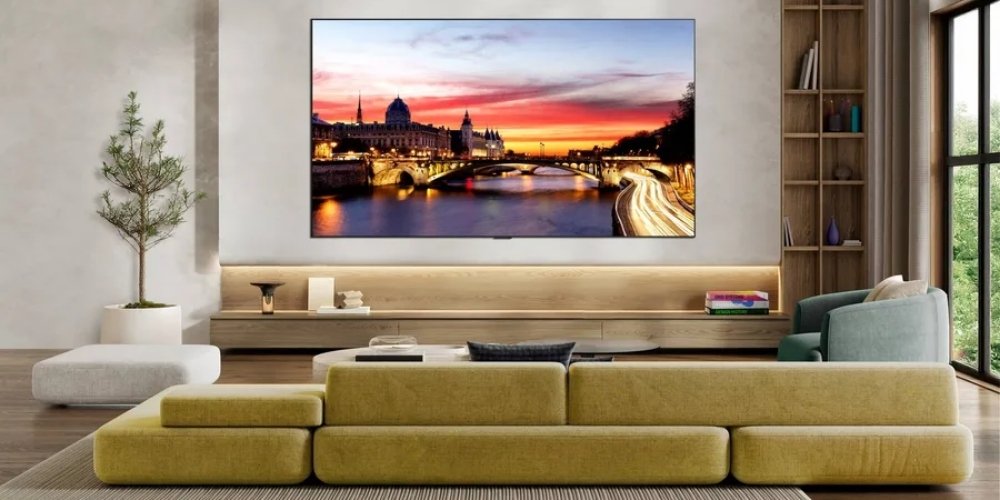 Lg OLED42C6 accroché au mur dans un salon moderne, affichant un panorama urbain au coucher du soleil avec des couleurs chaudes et contrastées sur dalle OLED evo